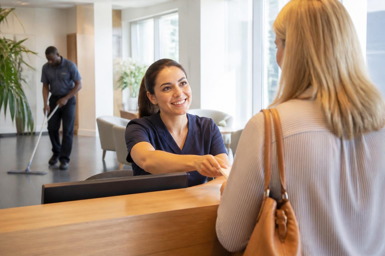 Home 2 Reception team greeting a client at a UK healthcare business